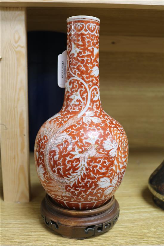 A late/early 19th century Chinese coral red phoenix vase height 29cm incl. carved stand